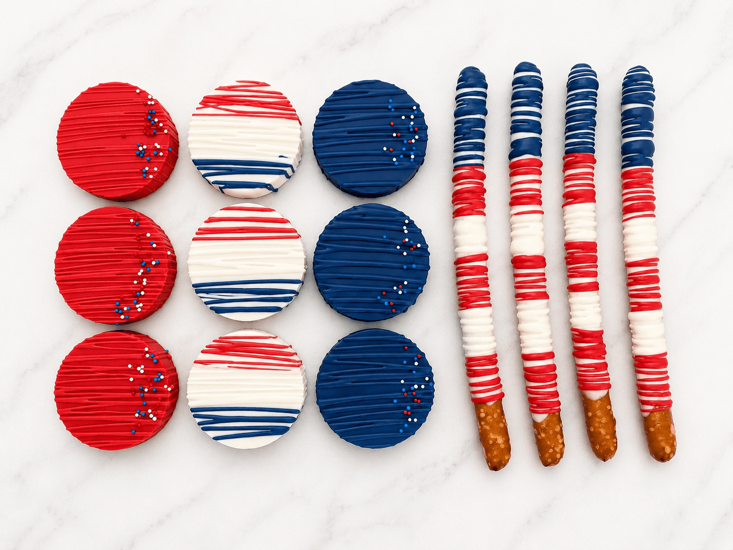 Red, white, and blue chocolate-dipped Oreos and pretzel rods arranged in a flag pattern